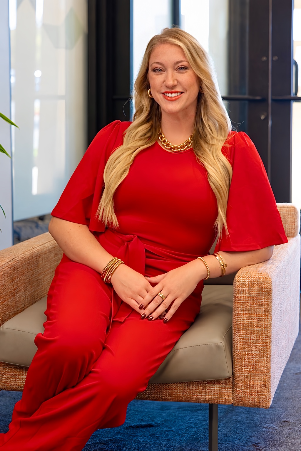 Alex Frost smiling in a red outfit