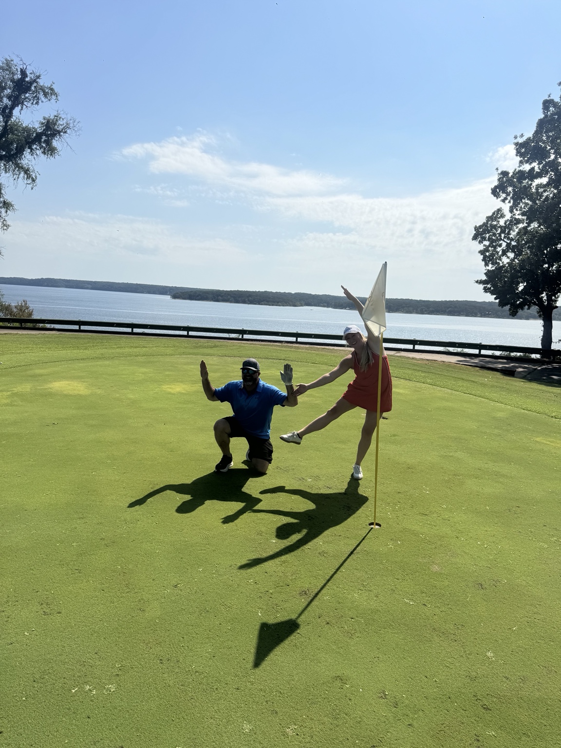 Alex and a colleague having fun at a golf event overlooking Grand Lake