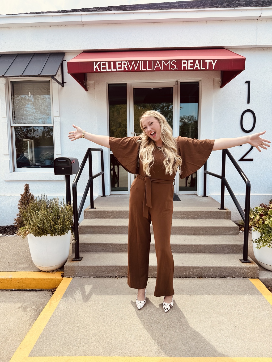 Alex welcoming people outside the Keller Williams office in Grove